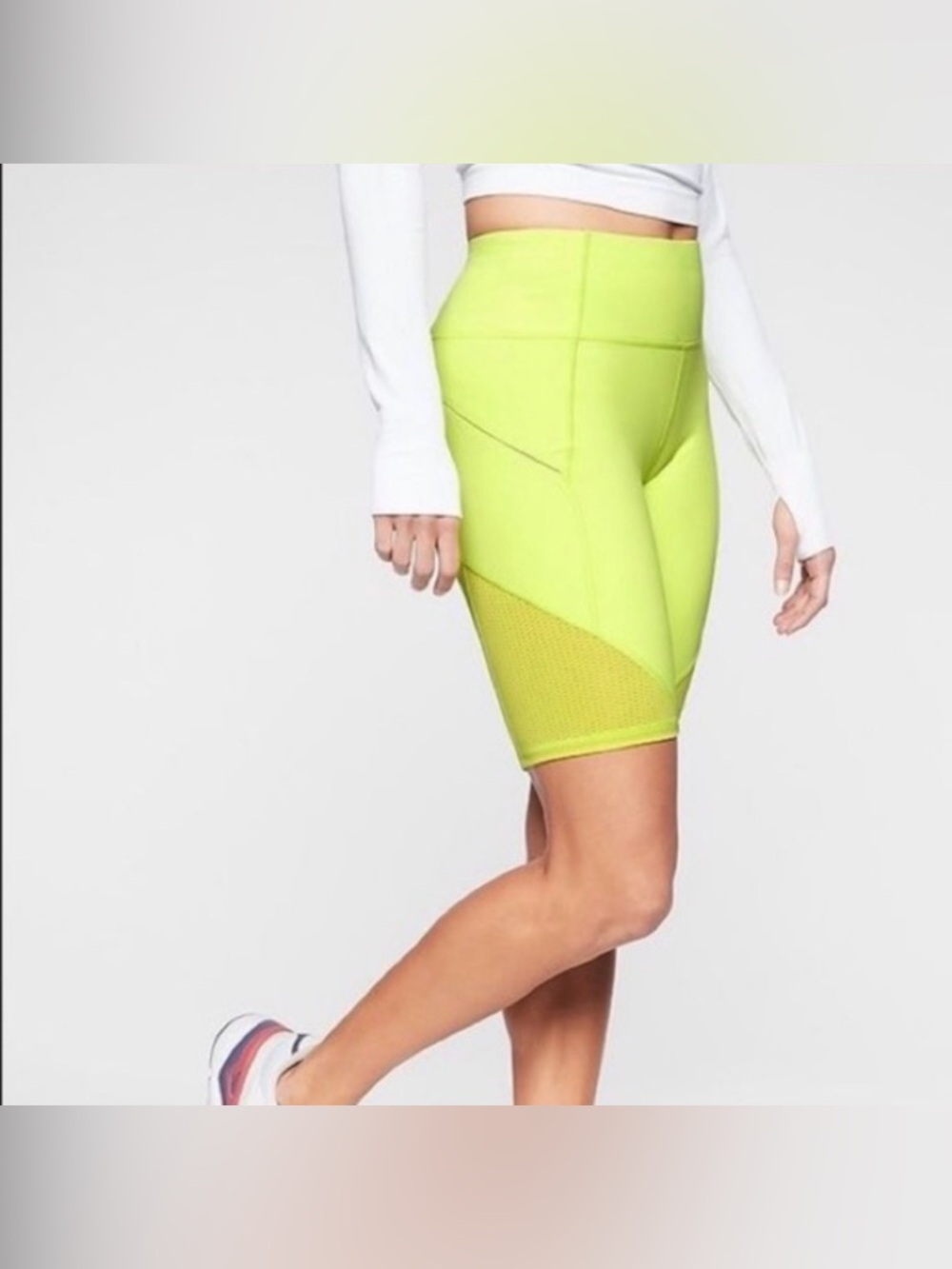 Athleta Contender 9” bike shorts in neon yellow/greenish color